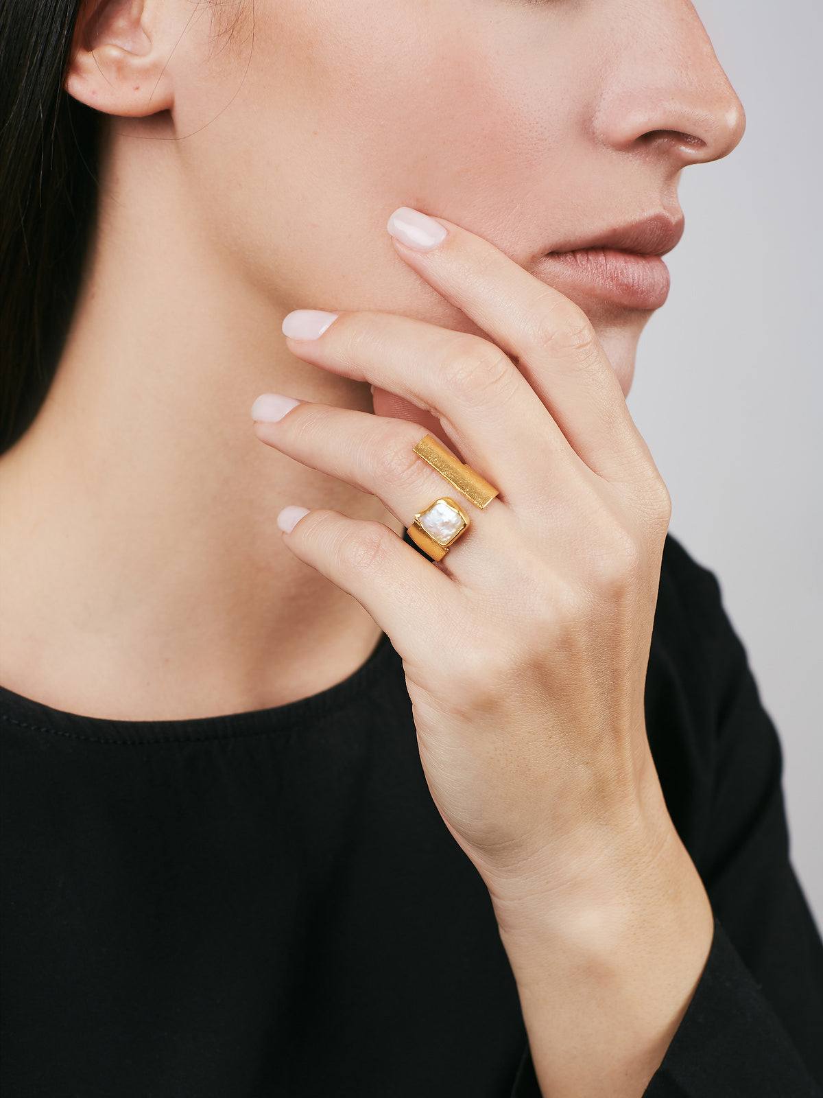 model wearing Silver Ring with Gold plated finish and a white Pearl
