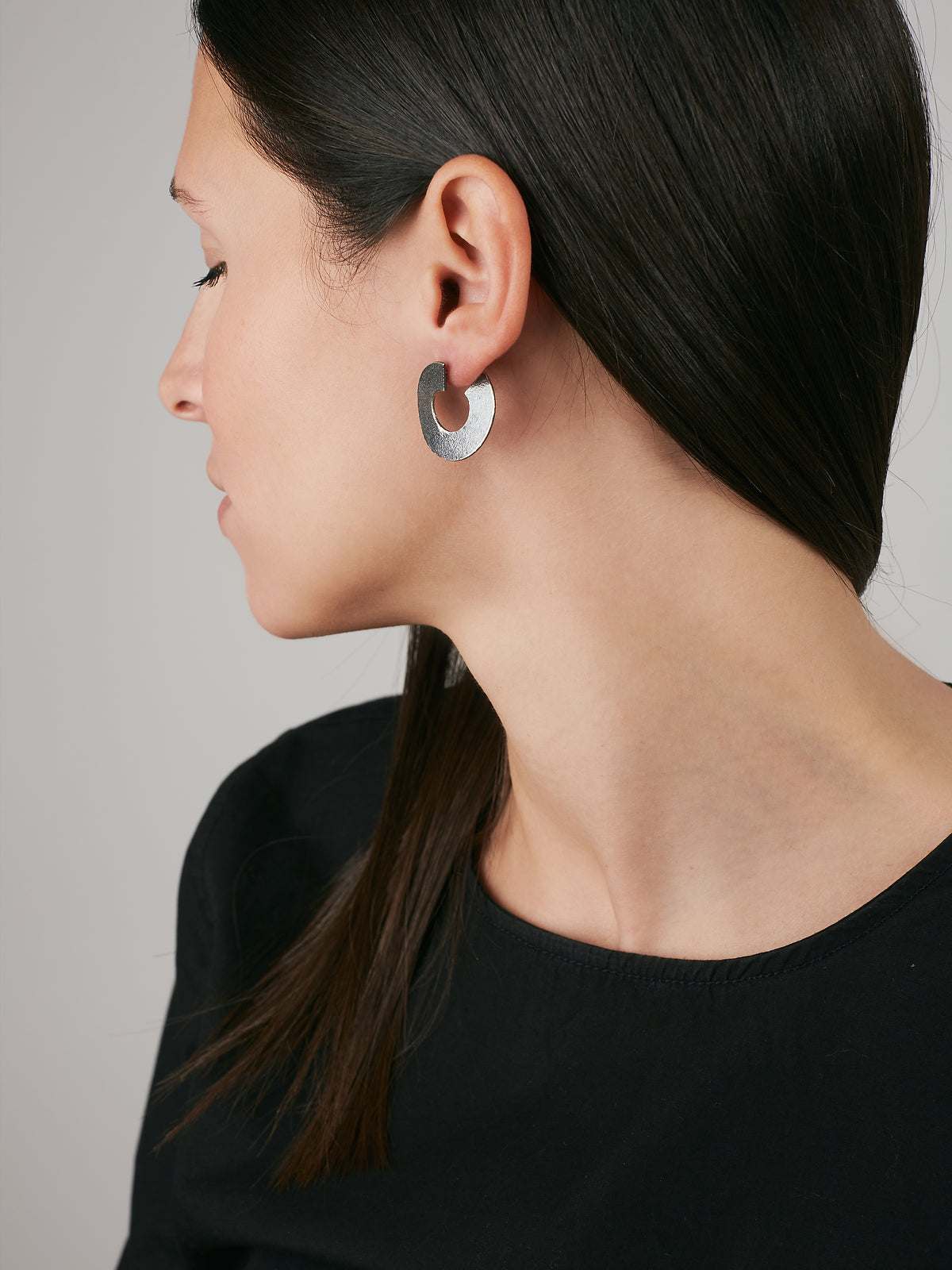model wearing Silver Earrings with an Oxidized finish