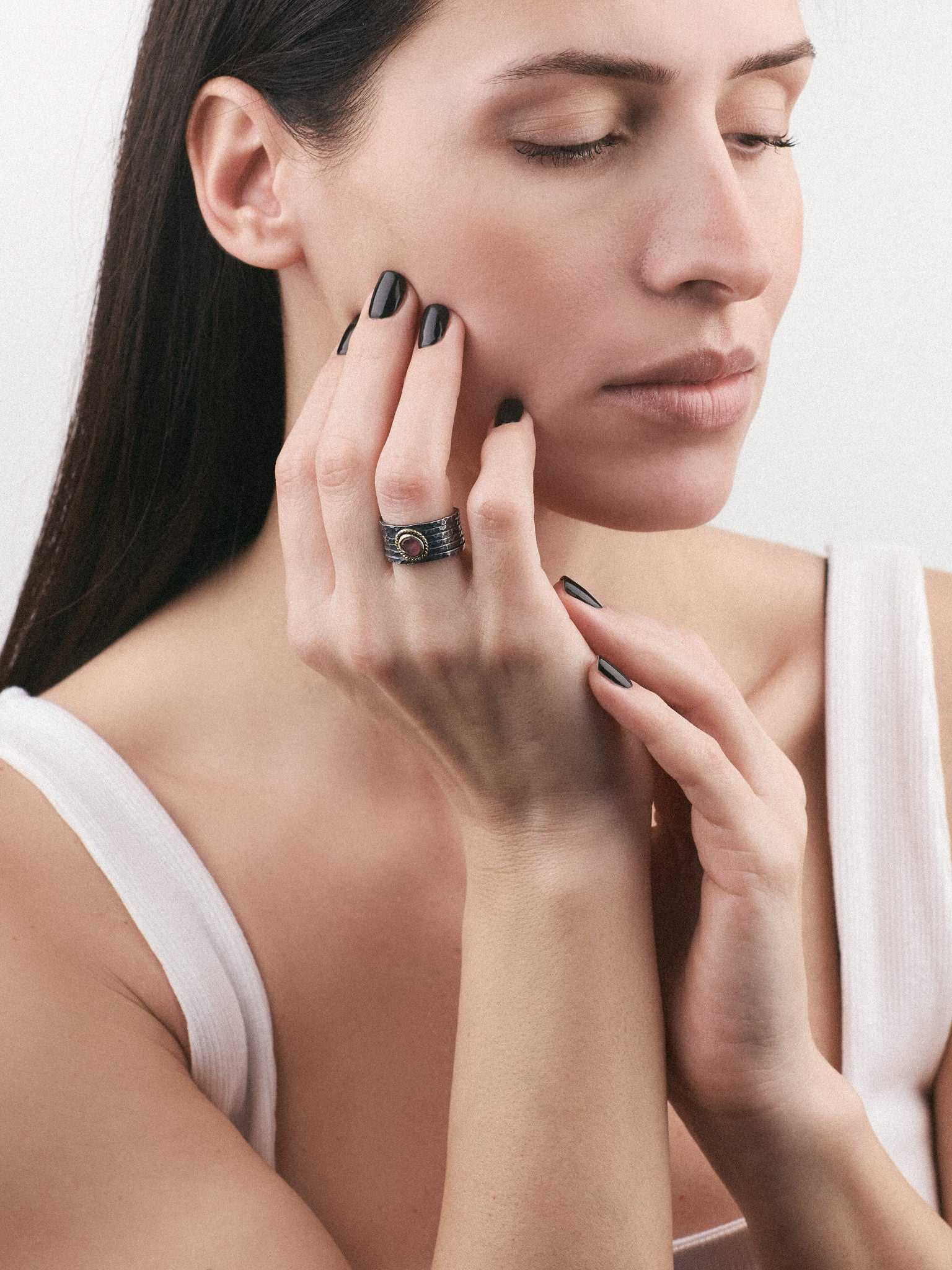 Model wearing Silver Ring with an Oxidized finish and a Ruby