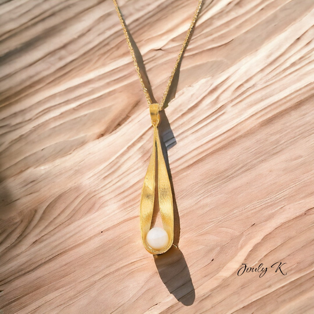 Jouly K handmade gold-plated silver necklace with a white pearl pendant. Elegant, sophisticated design.