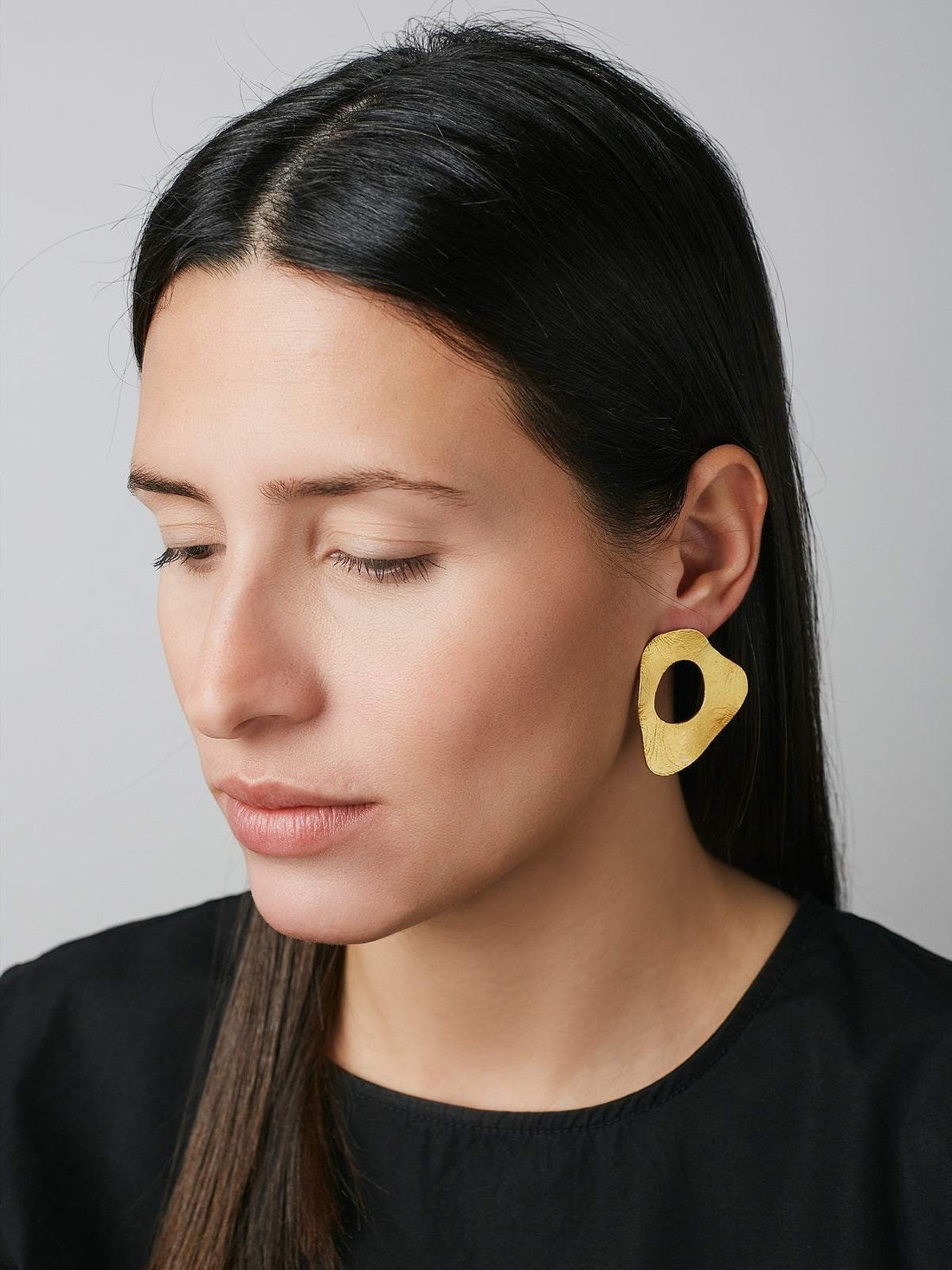 Jouly Khi handmade abstract gold plated silver earrings with an organic shape and cutout detail.
