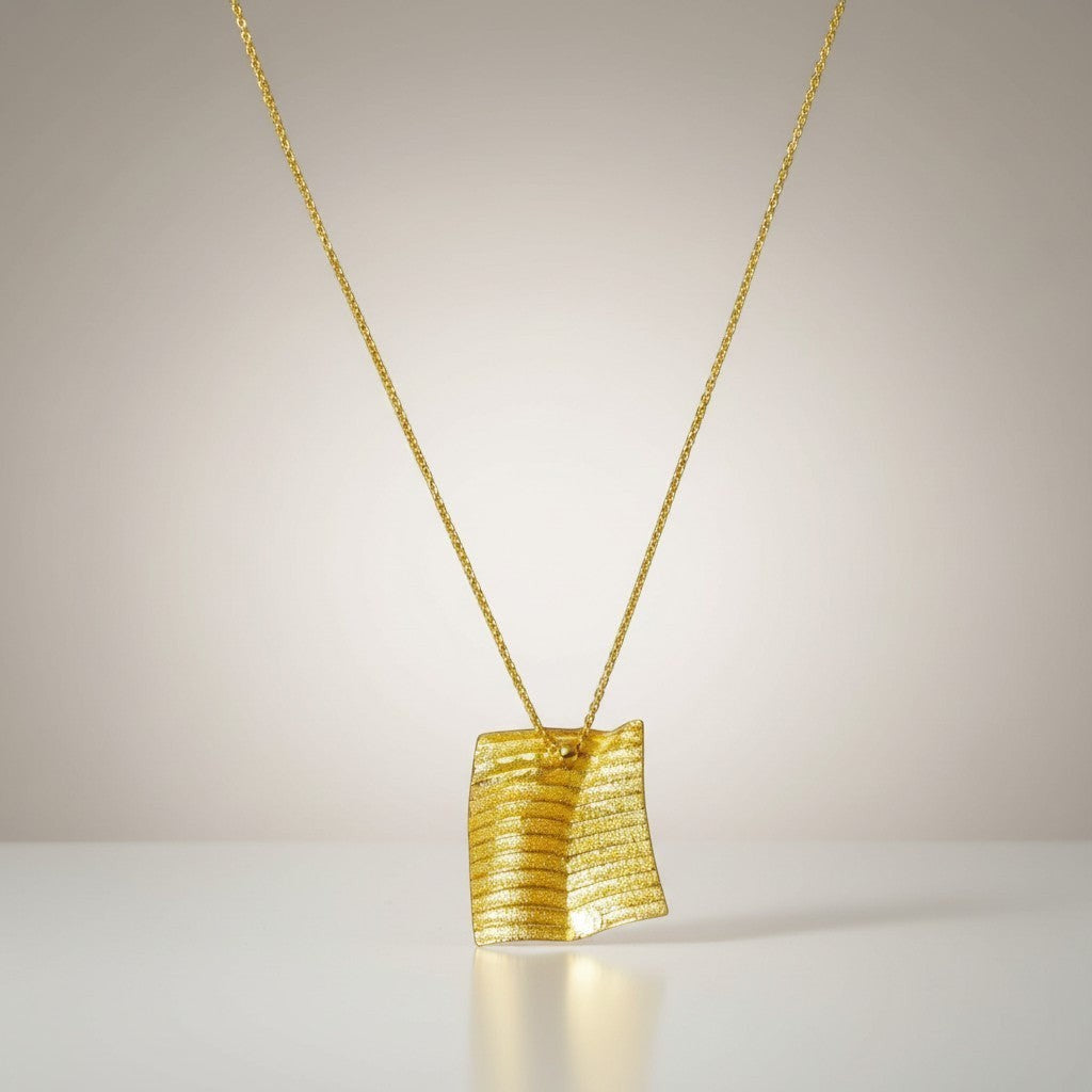 Jouly K handmade silver necklace with gold plated finish, featuring a textured square pendant and adjustable chain.