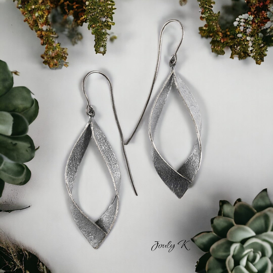 Jouly K silver earrings with an oxidized finish, featuring a twisted, elongated oval shape. Handmade, 925 silver.