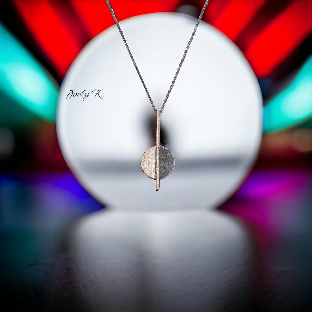 Jouly K handmade silver 925 necklace with an oxidized finish, featuring a geometric pendant with a vertical bar and circle.