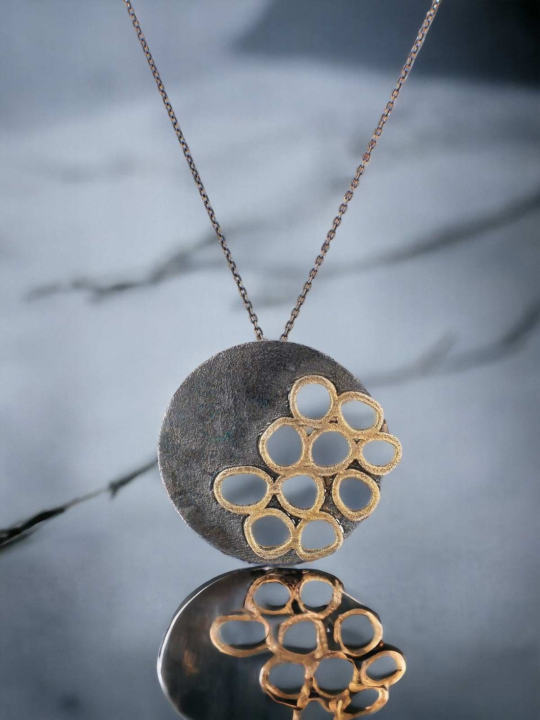 Jouly K handmade silver 925 necklace with oxidized finish and gold-tone circular cutouts.