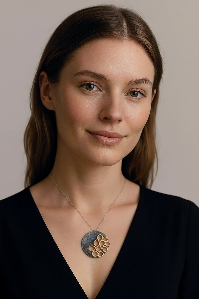 Jouly K handmade silver 925 necklace with an oxidized finish and a circular pendant featuring a honeycomb-like design.