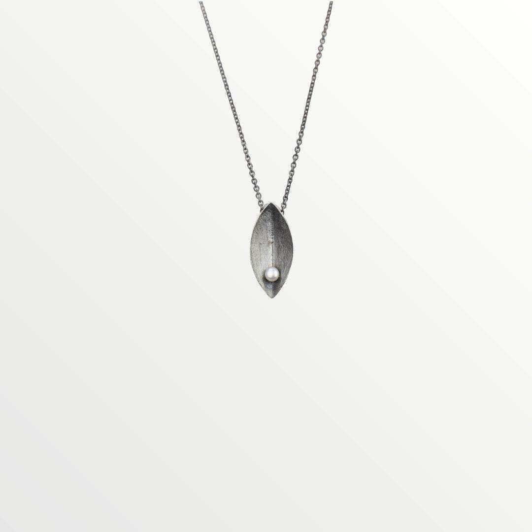 Jouly K handmade oxidized silver necklace with a white pearl accent. Leaf-shaped pendant with adjustable chain.