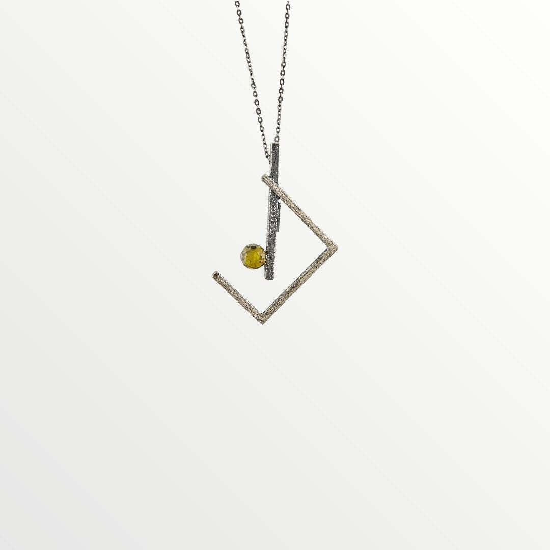 Jouly K handmade silver necklace with oxidized finish and a green glass gem. Modern geometric design.