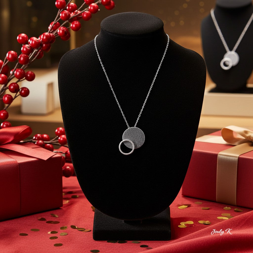 Jouly K silver necklace with oxidized finish, featuring two interlocking circles, one textured and one smooth.
