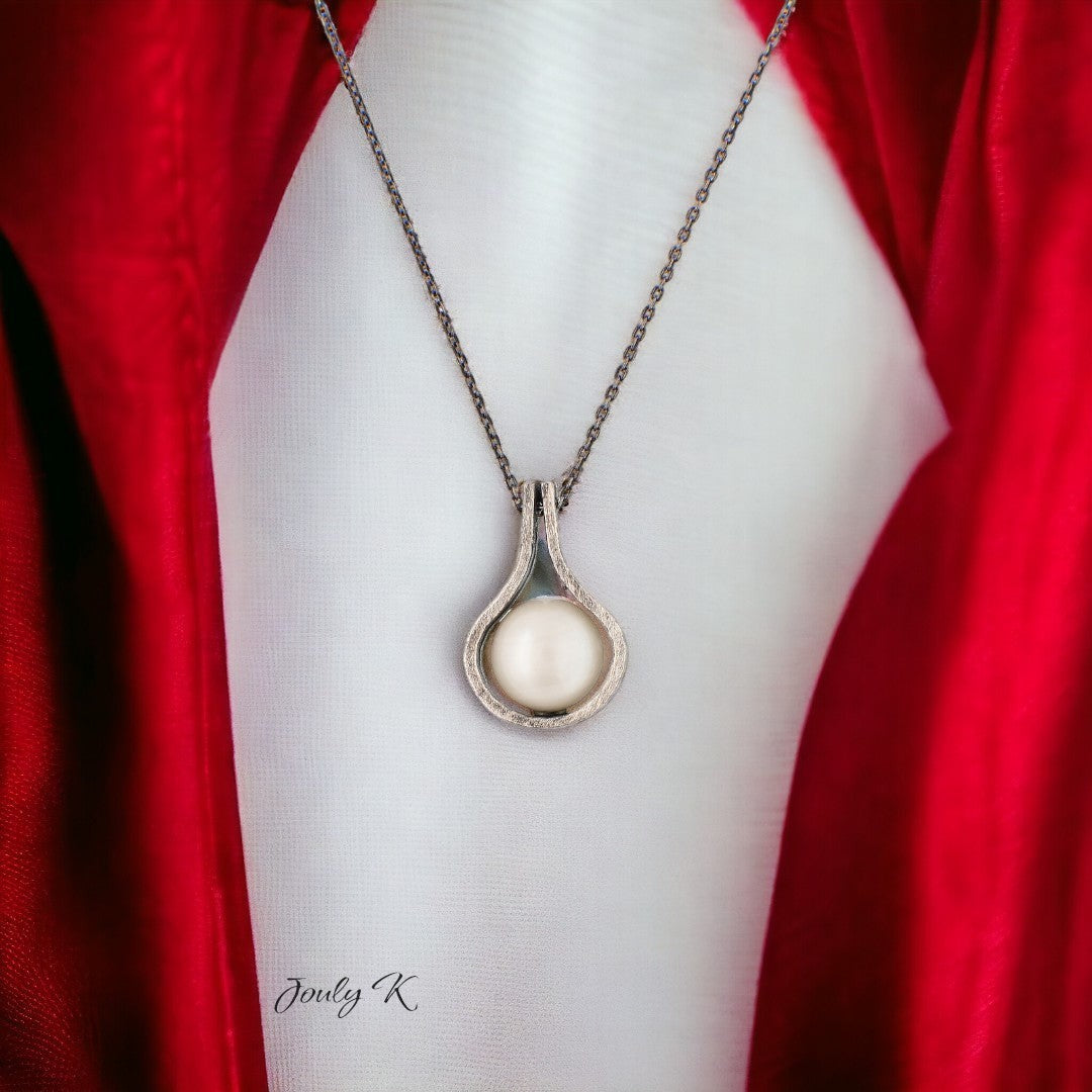 Jouly K teardrop pendant necklace with a creamy white pearl in antiqued silver-tone metal.