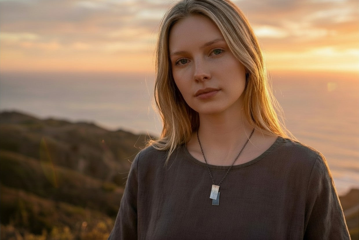 Lady wearing a silver necklace from Jouly K whilst enjoying the sunset